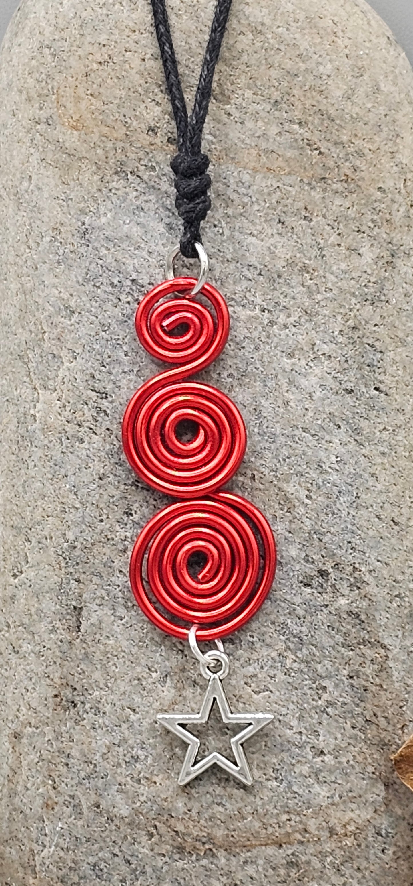Red spirals star pendant