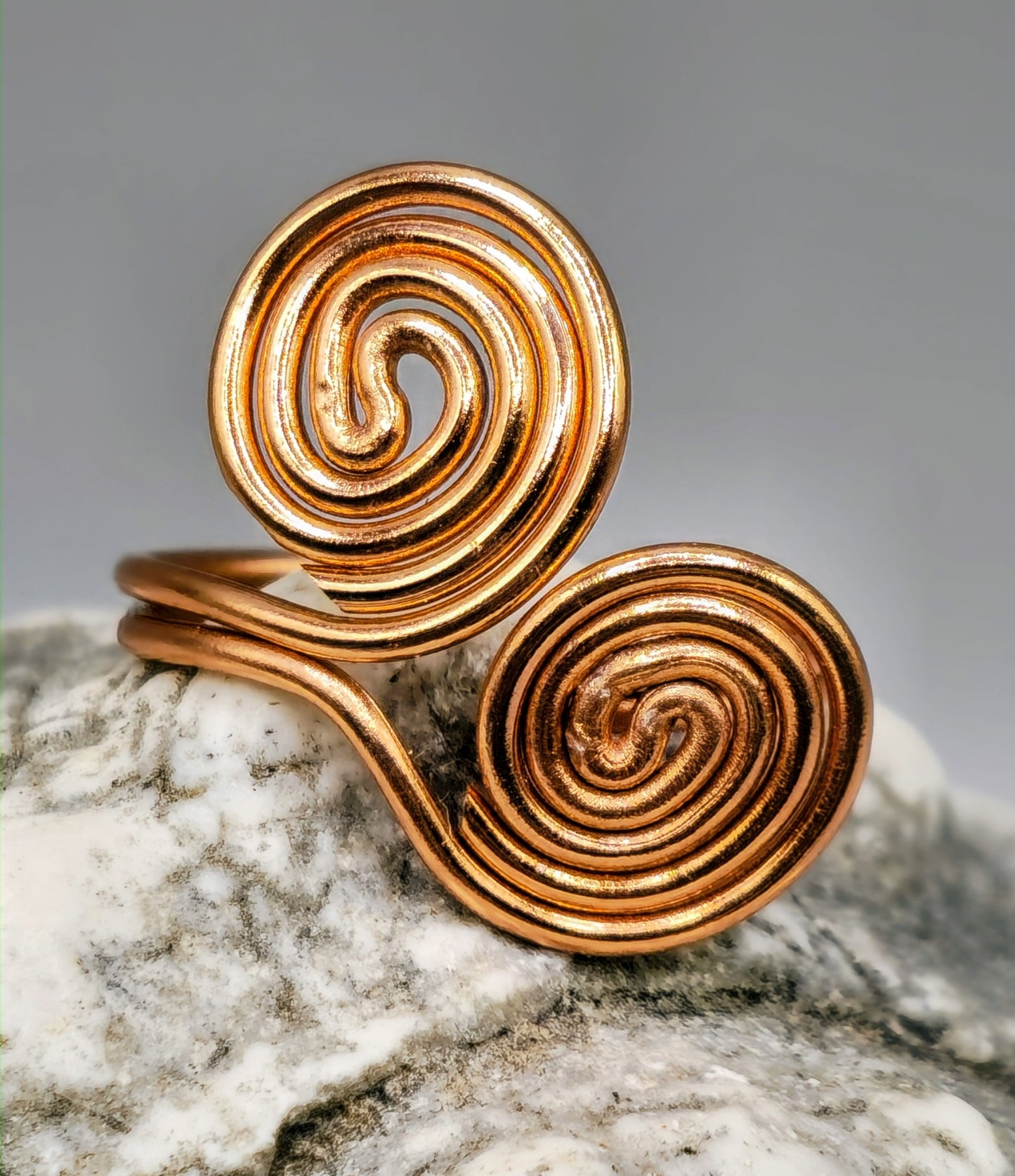 Copper coloured twin spiral ring