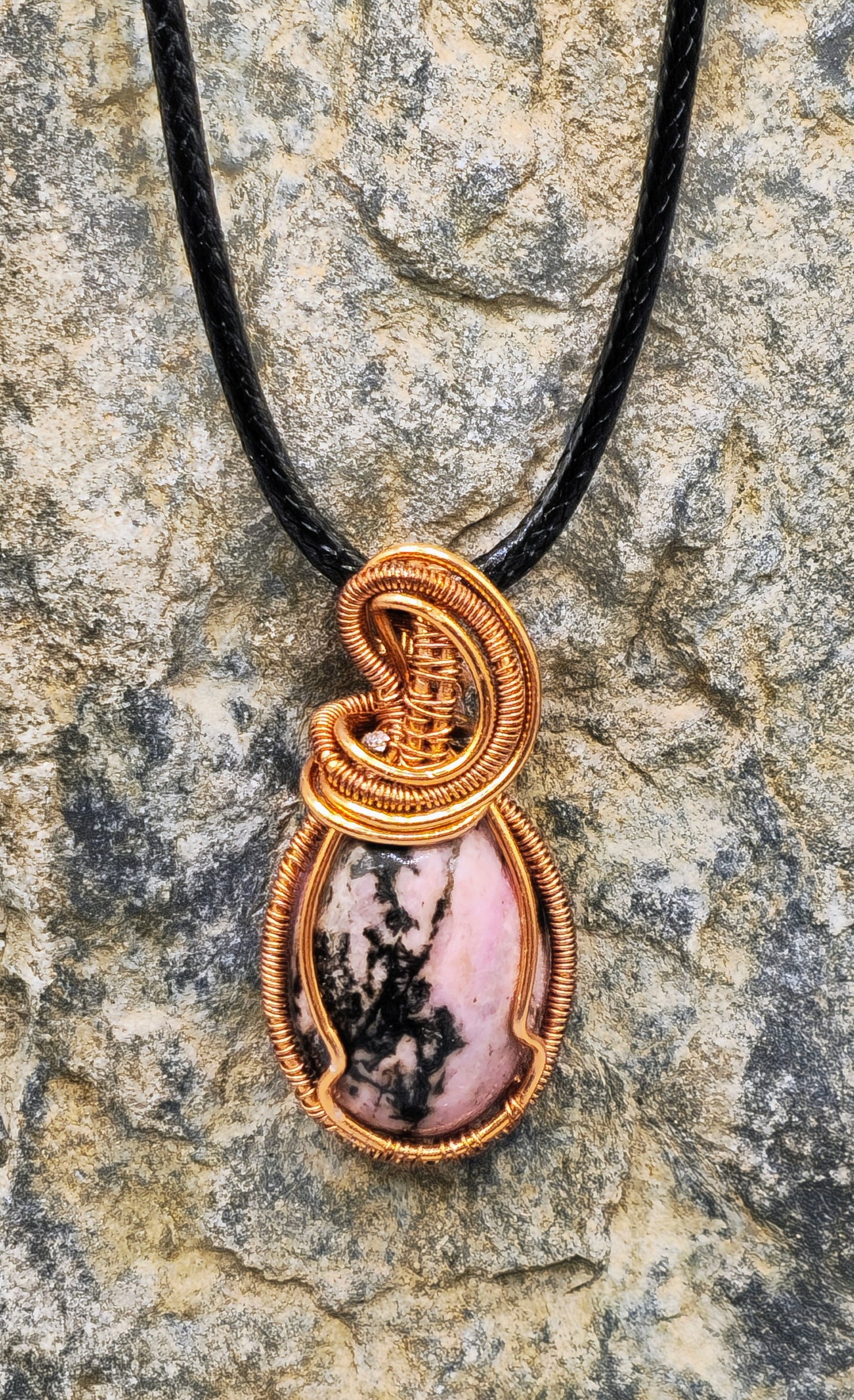 Copper-coloured wire wrapped stone pendant