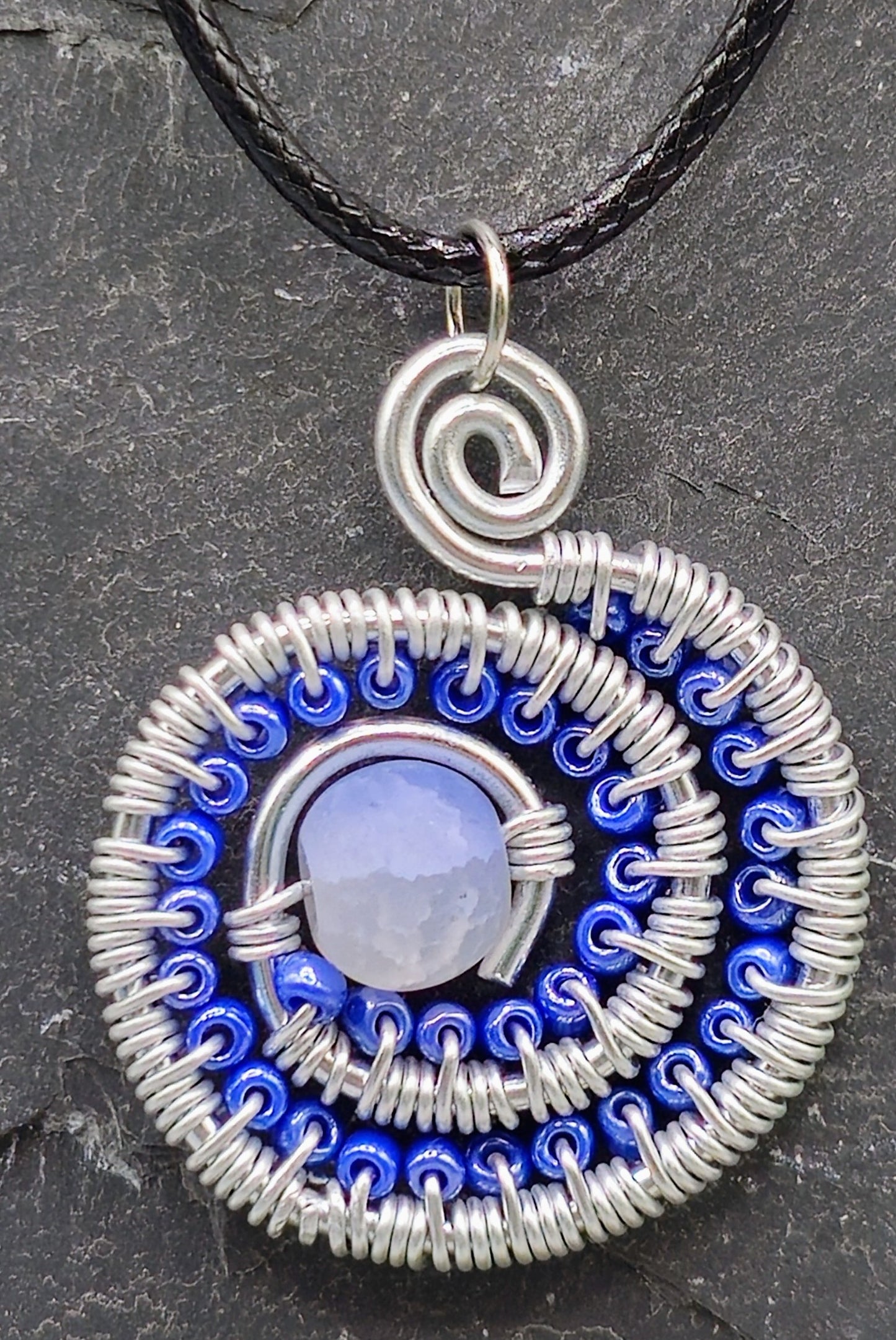 Blue and silver beaded spiral pendant