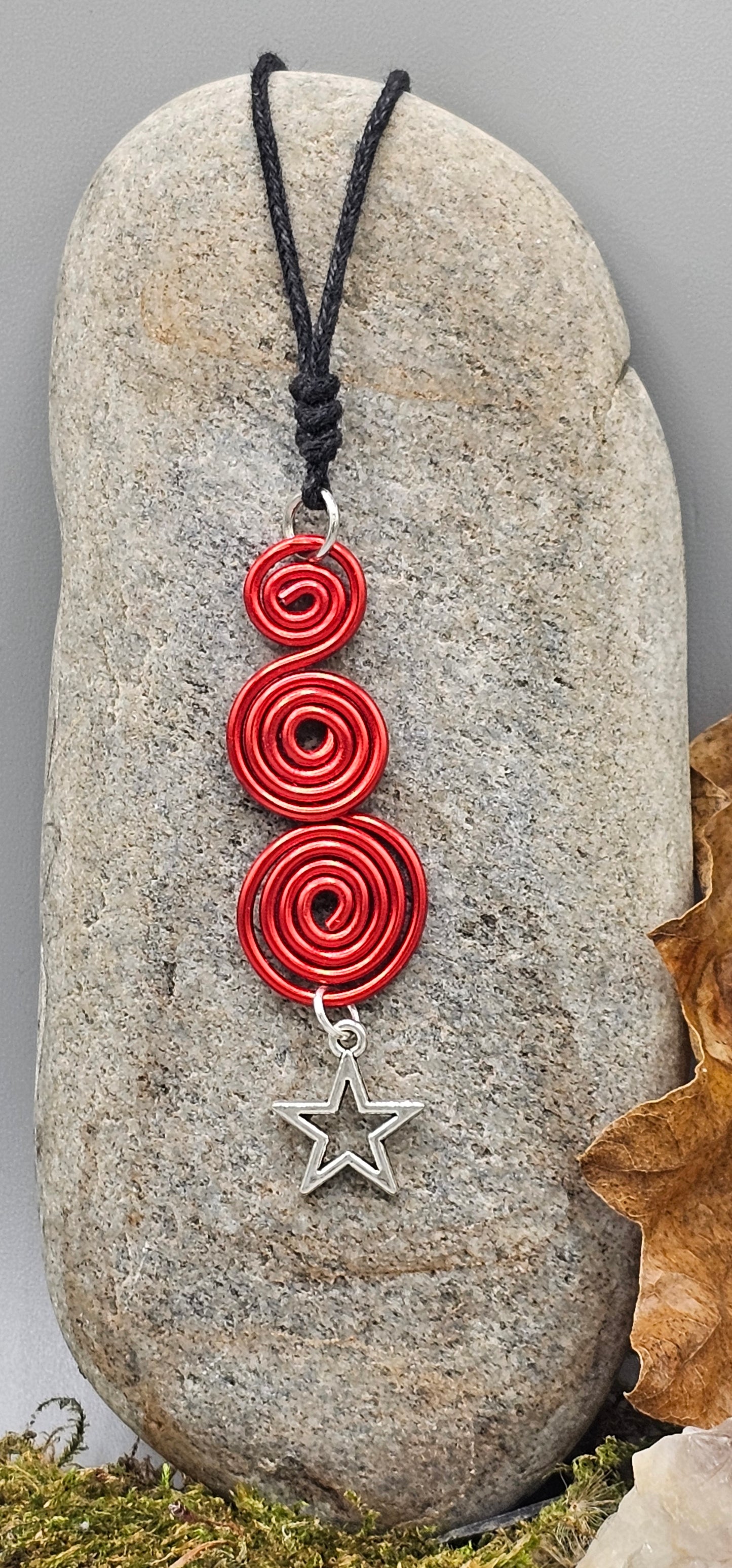Red spirals star pendant